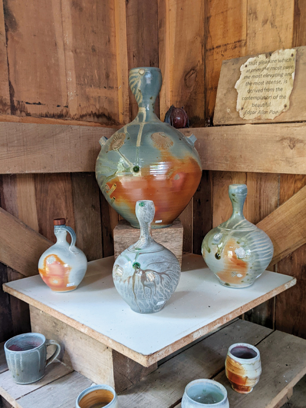 3 Wood- and soda-fired porcelain and stoneware bottles, mugs, and yunomi on display at the 2022 Michiana Pottery Tour (alternate view).