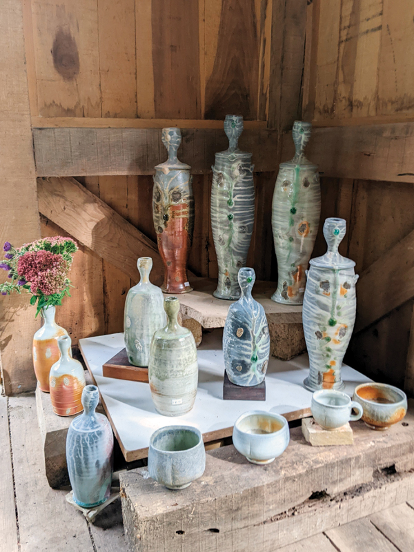 2 Wood- and soda-fired porcelain and stoneware bottles, mugs, and yunomi on display at the 2022 Michiana Pottery Tour.