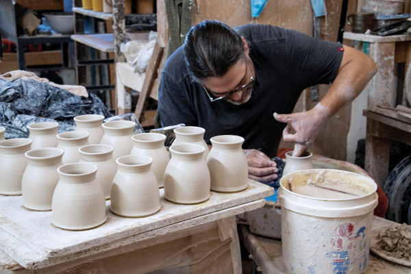 6 Goertzen throwing porcelain mugs for his production line. 