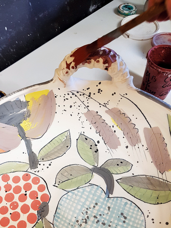 16 Brush a transparent glaze over the handles to enhance their textures and give them a similar color palette.