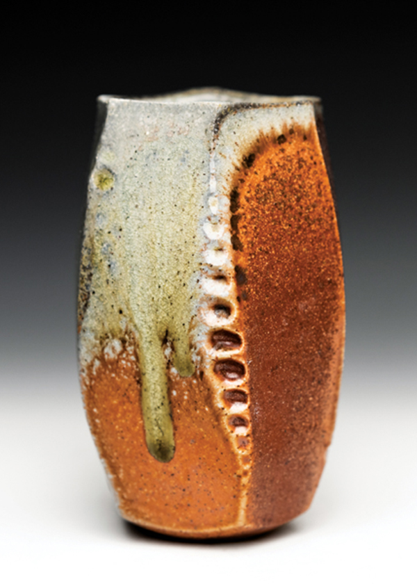 18 Alex Olson’s wood-fired yunomi, 5 in. (13 cm) in height, wheel-thrown and altered B-mix clay with grog, shino liner glaze, wood fired to cone 10 in reduction, 2021.