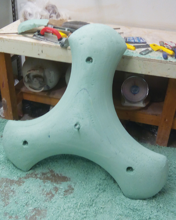 4 The foam model after finishing the form with rasps and drywall sandpaper. The holes in the three tiller arms allow for bolting the two sides together. This made it easier to separate them after making the mold. 