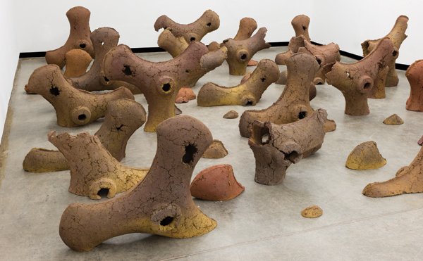 Detail of the final installation of the tiller forms. The forms taken from the two-part mold were further altered to give the sense that the tillers are emerging from or sinking into the ground in a farm field.
