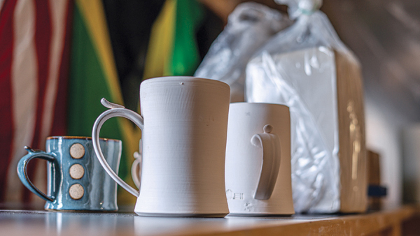 1 Preparing mugs to be glazed. Photo: photophobic images. 