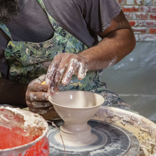 7 Brown throwing a gaiwan off the hump, then using calipers to measure for the gaiwan’s lid. Photo: photophobic images.