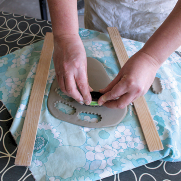 1 Use a cookie cutter to cut domino shapes from a clay slab.