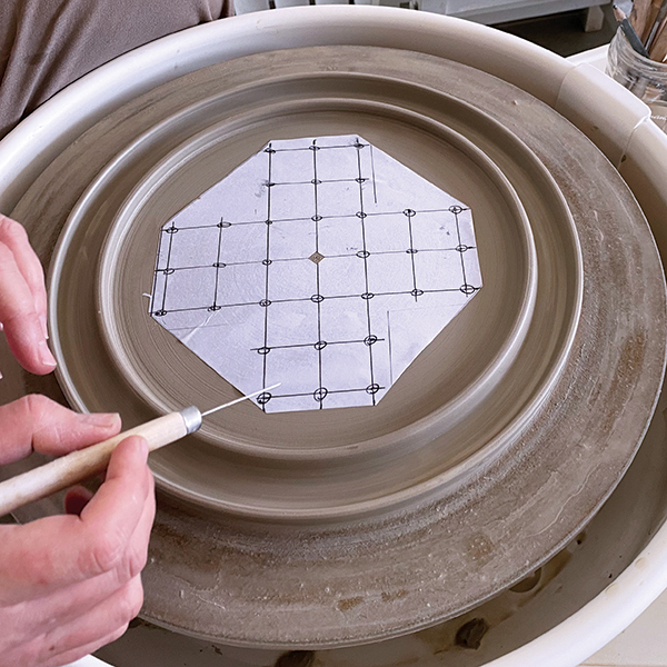 5 Place the paper grid and mark the grid locations with a needle tool.