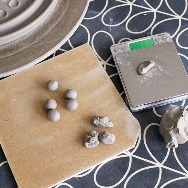 7 Weigh out and roll each clay marble into a round ball.