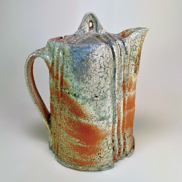 2 Eric Ordway’s covered pitcher, 7 in. (18 cm) in height, stoneware, flashing slip, wood fired to cone 12, 2021. 