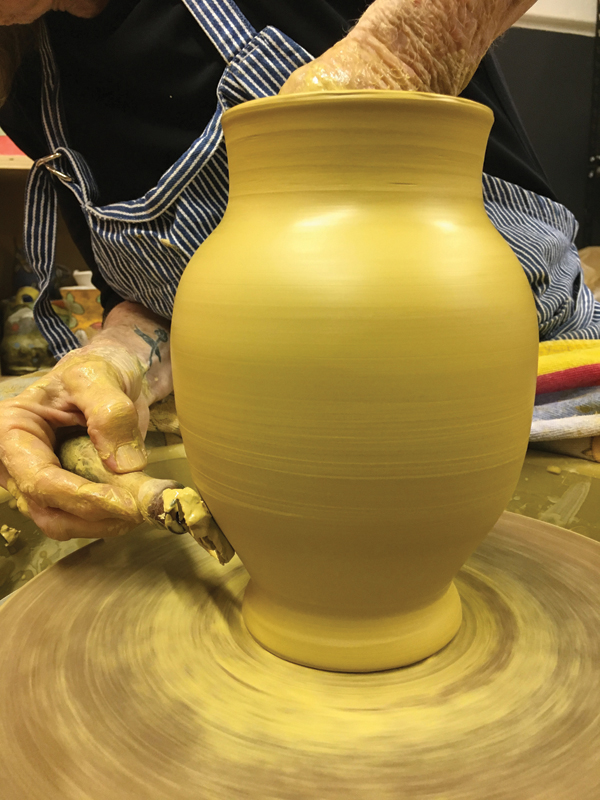 1 Throw a tall vase form on the wheel, trim it, and allow it to form up just enough so it can still be manipulated.