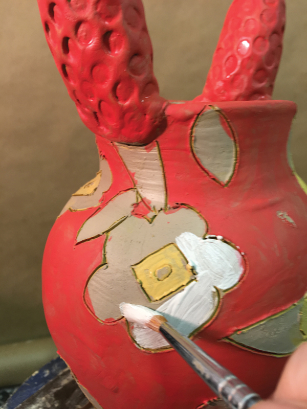 5 Brush the drawings with various colors of commercial underglazes. The coverage of the underglaze can vary throughout.