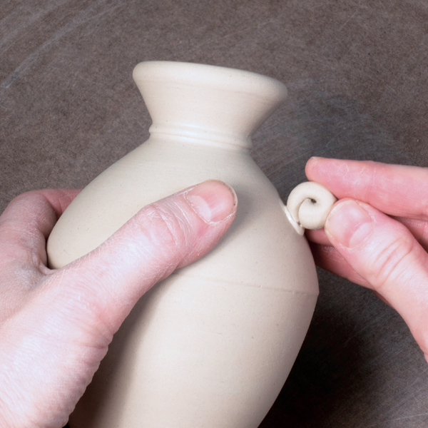 9 Press spiral handles into dabs of slip to connect them to the form.