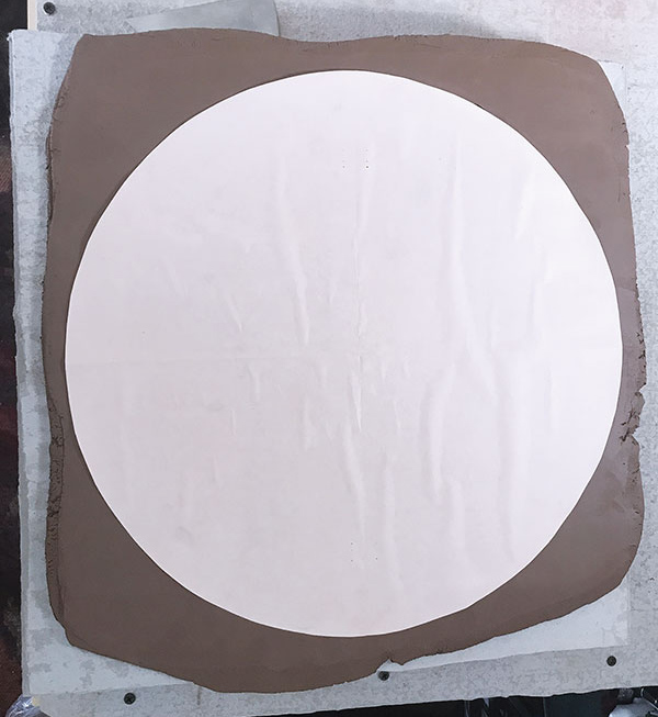 1 Lay the damp paper template onto the ⅜-inch-thick slab. 