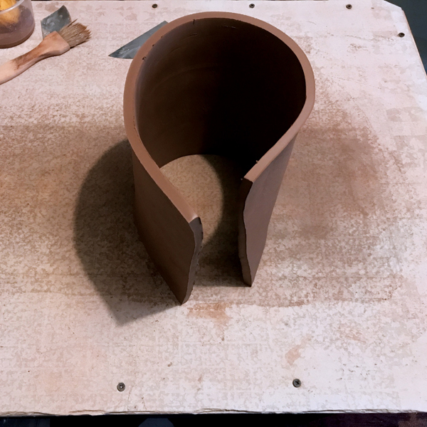 2 Carefully stand the slab up, and shape it into a rough oval.