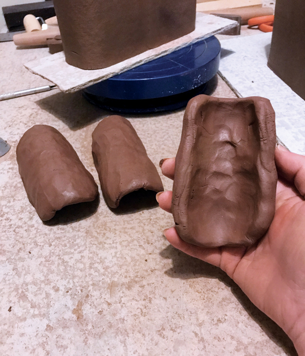8 Pinch and thin each coil into an arch-shaped slab.
