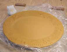 9 With plastic in place, smooth rim with thumb and forefinger using a little downward pressure to seat the edge in the mold. Dry slowly.