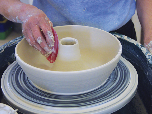 5 Smooth the inside surface with a soft rib. Cut the center cone to just a bit shorter than the outer wall.