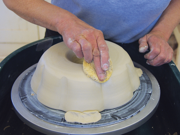 8 Trim excess clay from inside the cone and a little at the base of the outer wall. Use a sponge to smooth the exterior.