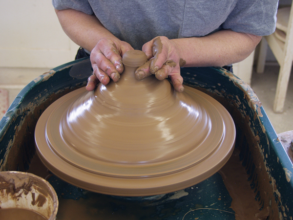 6 To throw a lid right side up, pull up a bottomless ring slightly wider than the measurement, then collar it closed.