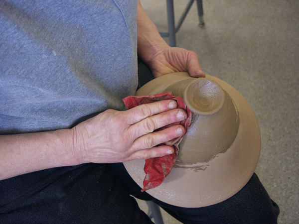 9a Use a damp rag, then your fingertips, then a polished stone to smooth and burnish the slip. 