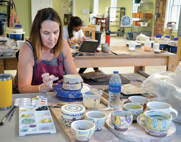 4 Pocosin Arts student explores creating imagery on clay at a Bede Clarke workshop.