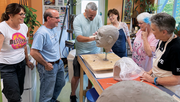 Workshop attendees look on during a demonstration on fixing ears at the Blackberry Hill Art Center.