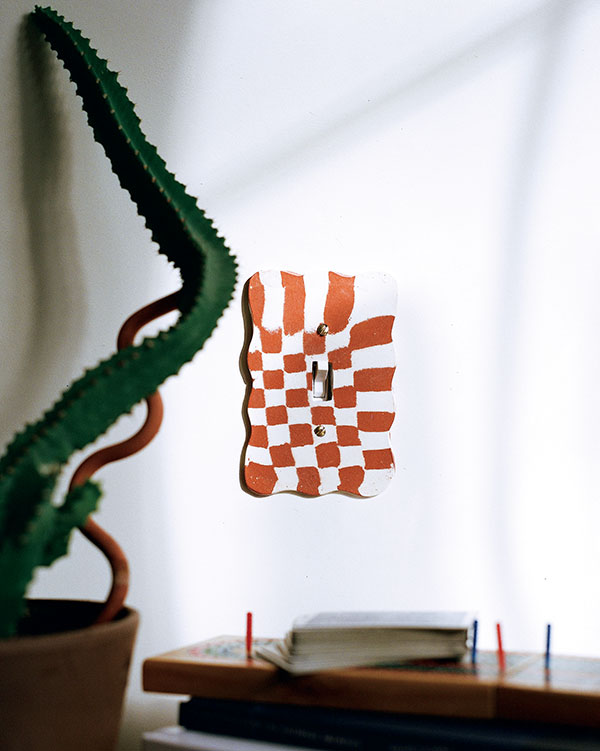 Wavy nerikomi light switch cover with red and white clay bodies. Photo: Zoe Prinds-Flash. 