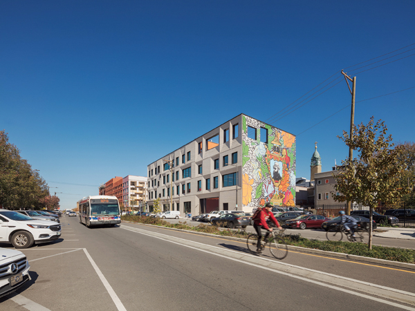 1 The Clay Studio, DIGSAU Architects, exterior view in the bustling urban neighborhood. South-facing wall features The Talented Mr. Trotter: You Can Be Anything (mural), by Roberto Lugo and Mural Arts Philadelphia, 1425 N. American Street, Philadelphia, Pennsylvania. Photo: Sam Oberter. 