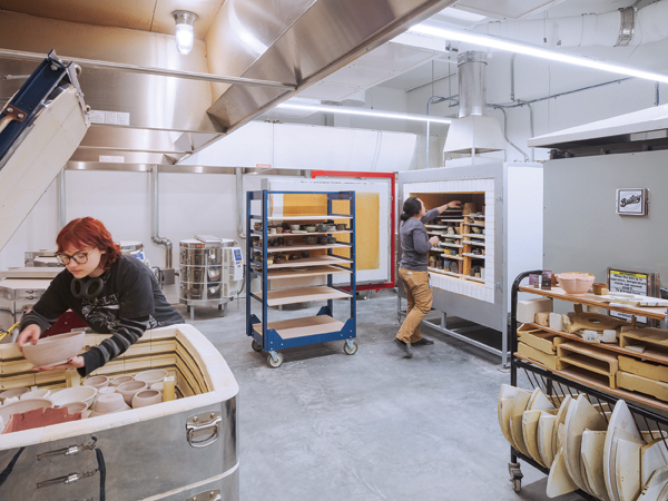 8 The Clay Studio school kiln room with artist and studio technician Duc Tang, with electric and gas kilns installed by All Kiln Services. Photo: Sam Oberter.
