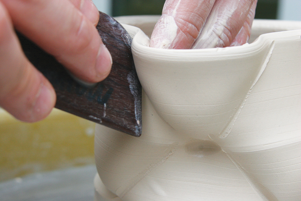 5 Roll the wooden rib between two points, while using your left hand to push out the area above the wooden rib.