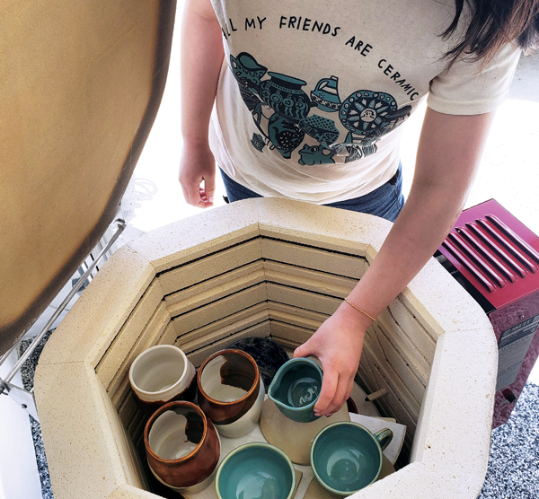 4 Kiln owner unloading glazed ceramics. Photo: @curvypotshandmade.**