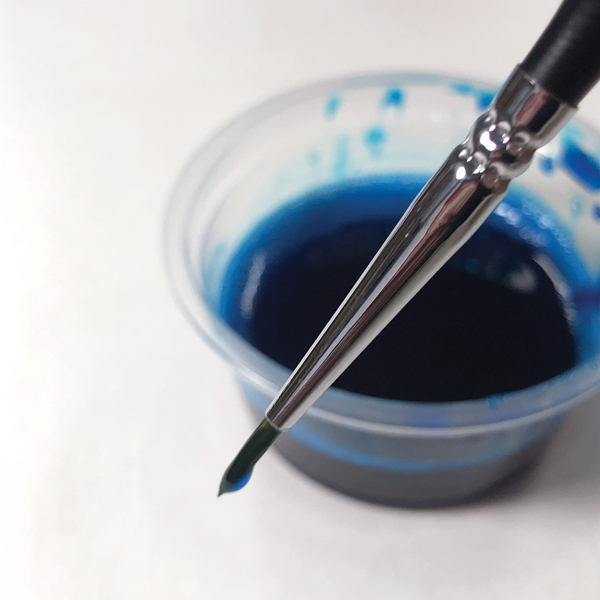 3 Load the brush so that a small amount of drawing fluid accumulates at the tip.