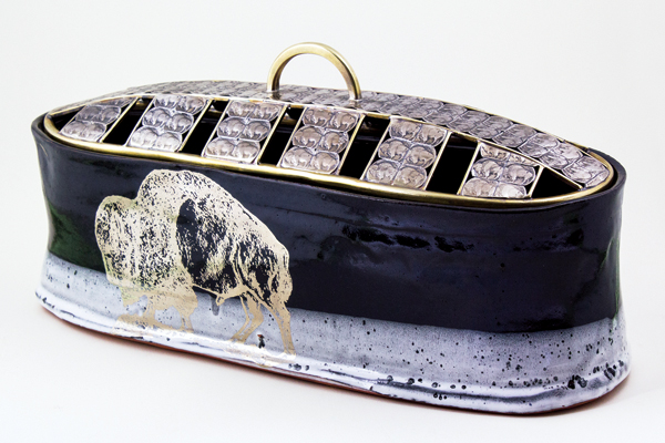 7 Stacey Lee Webber and Justin Rothshank’s Buffalo Nickel Vessel, 22 in (56 cm) in length, wheel-thrown earthenware, glaze and decal decorated by Justin Rothshank with platinum-luster decals by Milestone Decal Art, lid made of buffalo nickels by Stacey Lee Webber. 2017. 
