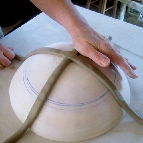 1 Extrude several 1-inch-diameter coils. Cross two coils on a convex plaster hump mold.