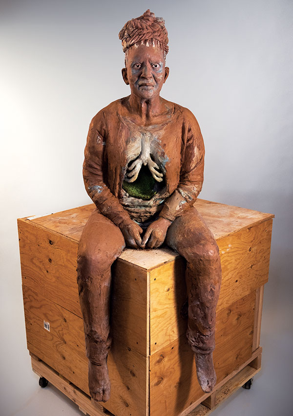 5 Woman with Graves at Her Back, 5 ft. 1 in. (1.5 m) in height, unfired clay before being cast in bronze, handbuilt solid with black-pipe armature, 2021. Photo: Misael Martínez.
