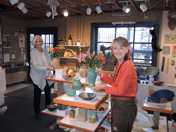3 Marcia Cochran (left) and Evelyn LaMers (right) put out fresh flowers.