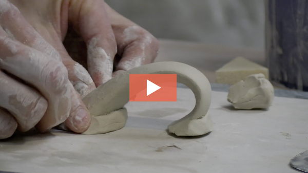 Doug Peltzman adds clay to a pulled handle.