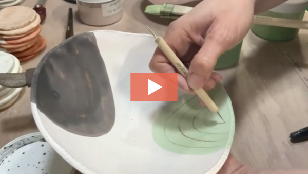 image of Rhonda Willers carving a terra sigillata surface on a bowl.
