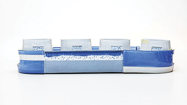 18 Sara Alfieri’s Blue Stripe Tasting 4 Flight, 19 in. (48 cm) in length, white stoneware, fired to cone 5 in an electric kiln.