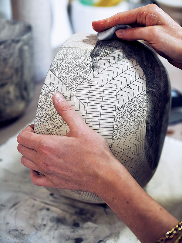 5 Frances Priest sponging away black stain on the surface of a vessel form, 2019.
