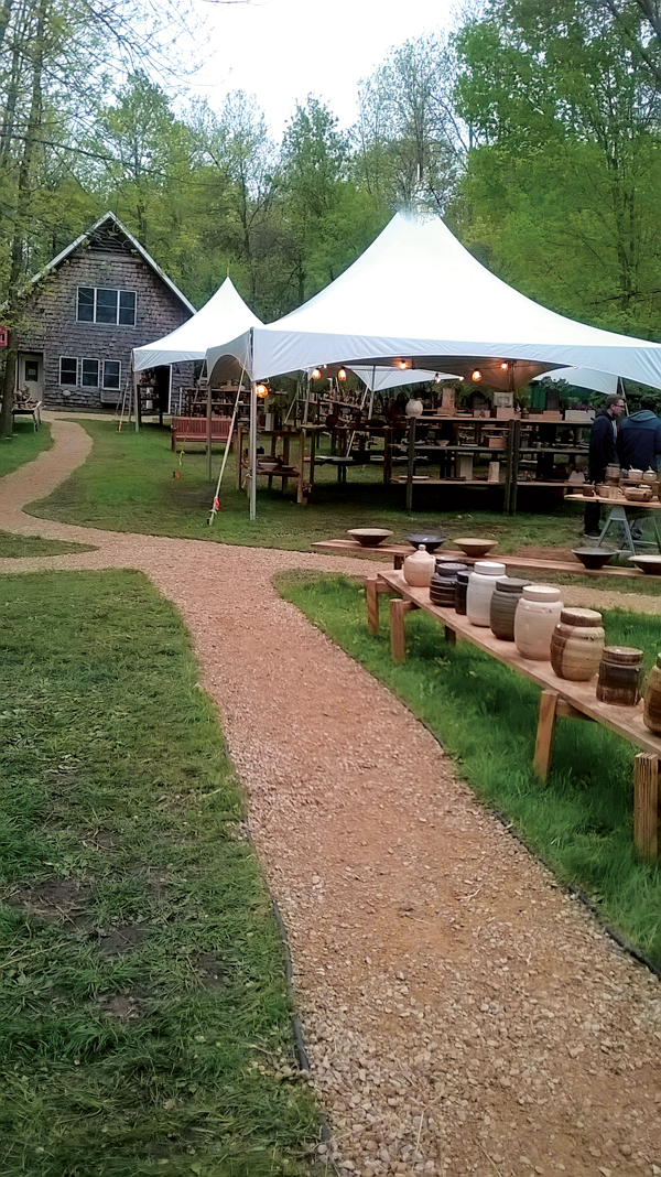 4 A portion of Matt Krousey’s table and tent set up for the St. Croix Pottery Tour. His studio sits in the background.