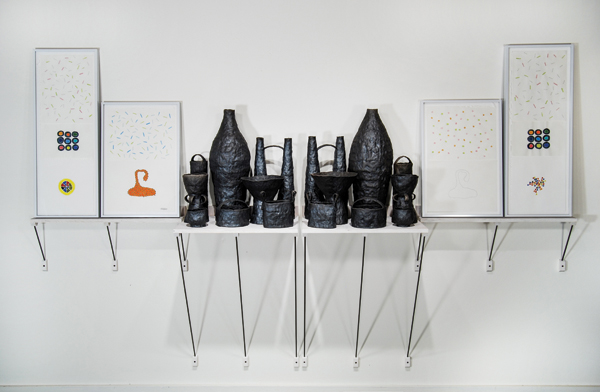 Between One and The Same, Part 1, 9 ft. 2 in. (2.8 m) in width, raku‑fired earthenware, mixed media on paper, frames, dyed plywood, steel supports, fasteners, 2011.
