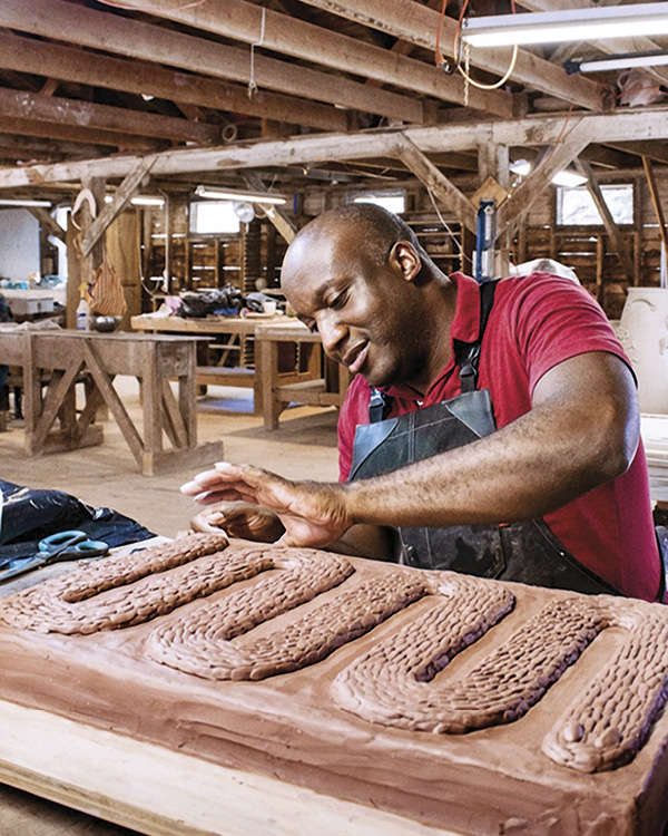 3 Ebitenyefa Baralaye working on Serpent I in the Watershed Center for the Ceramic Arts studio in 2019.