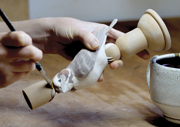 16 Clean underglaze off of the candle column with stiff bristle brush.
