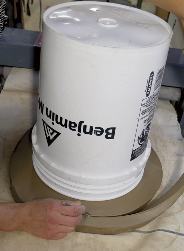1 Trim off excess clay from the slab around the bucket before flipping over.