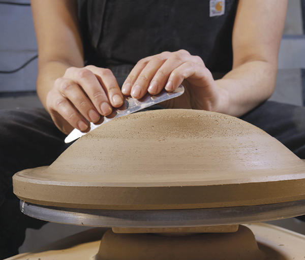 7 Once leather hard, use trimming tools and ribs to refine the convex curve of the bisque mold.