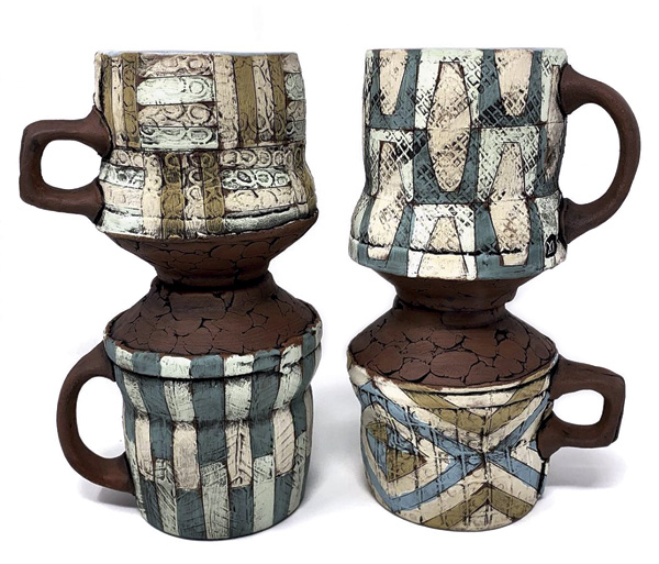 2 Mark Arnold’s mugs, 5 in. (13 cm) in width (each), red clay, Pete Pinnell’s Real Authentic Lip Smackin’ Smooth Easy Terra Sigillata in a variety of color variations, underglaze, glaze, fired to cone 4 in an electric kiln.
