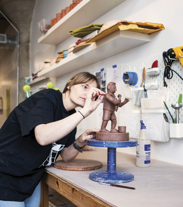 Molly Anne Bishop working on a sculpture in her studio.