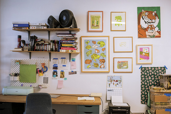 Artwork and wall storage on a wall in Molly Anne Bishop's studio.
