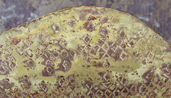 4 A sanded surface that has been covered with a soda ash wash and lithium carbonate wash layer to stabilize any further flaking, which also creates a weathered surface. This piece was made from earthenware and fired to cone 03 in an electric kiln.